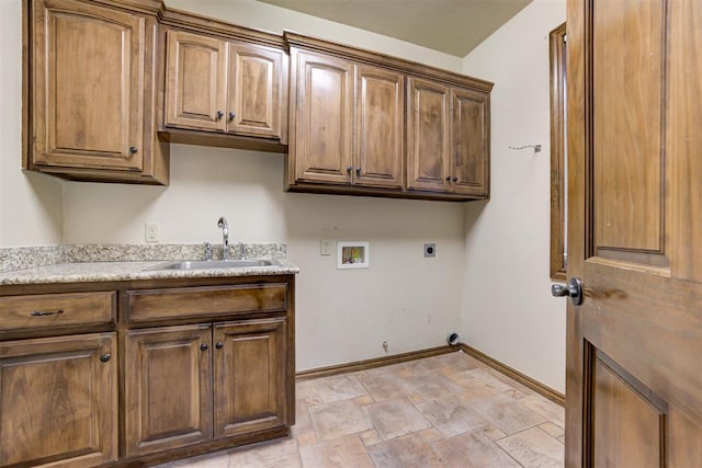 1918 Winding Ridge Rd, Edmond, OK 73034 - laundry room featuring cabinet space, hookup for an electric dryer, hookup for a washing machine, and light stone finish flooring