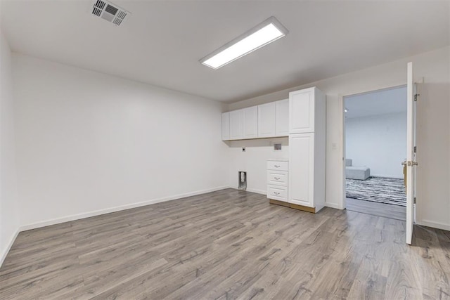 1918 Winding Ridge Rd, Edmond, OK 73034 - unfurnished living room featuring light wood-style flooring and baseboards