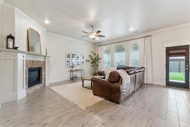 18813 Windy Way Rd, Edmond, OK 73012 - living area featuring light wood-style floors, a fireplace, a ceiling fan, crown molding, and baseboards