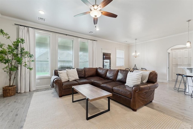 18813 Windy Way Rd, Edmond, OK 73012 - living area with arched walkways, ceiling fan, baseboards, light wood-style floors, and crown molding