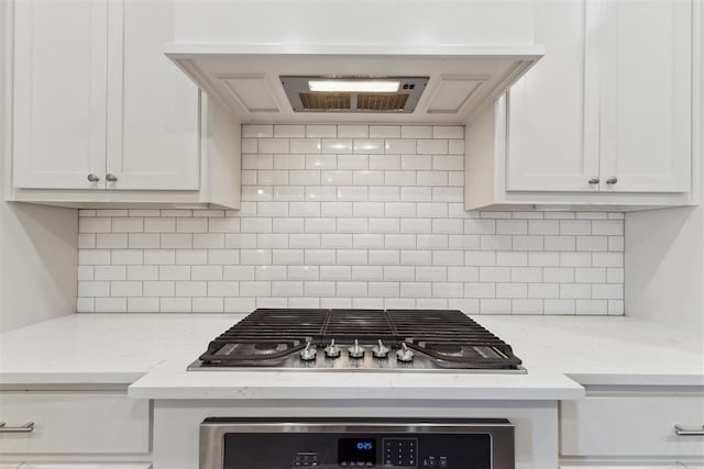 18813 Windy Way Rd, Edmond, OK 73012 - kitchen with stainless steel gas stovetop, white cabinetry, and decorative backsplash