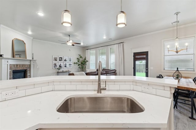18813 Windy Way Rd, Edmond, OK 73012 - kitchen featuring a sink, open floor plan, ornamental molding, decorative light fixtures, and ceiling fan