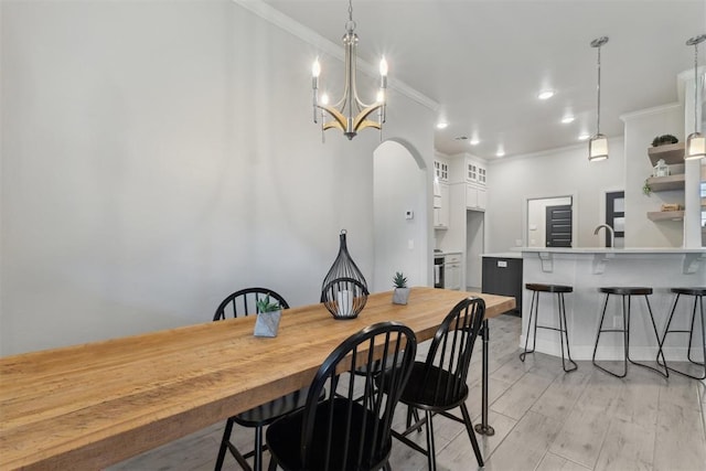 18813 Windy Way Rd, Edmond, OK 73012 - dining room featuring ornamental molding, light wood-style floors, and a chandelier