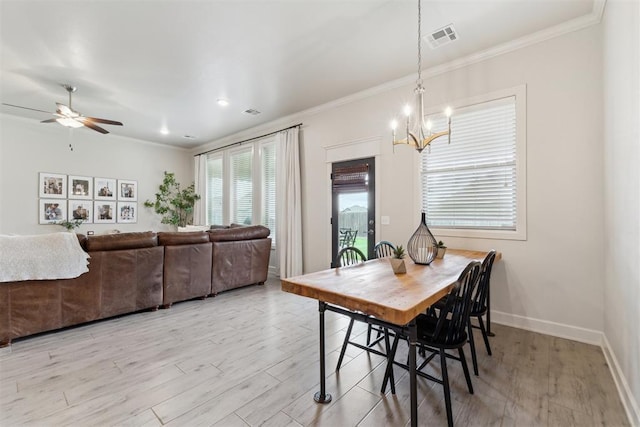 18813 Windy Way Rd, Edmond, OK 73012 - dining room featuring crown molding, light wood finished floors, a chandelier, ceiling fan, and baseboards