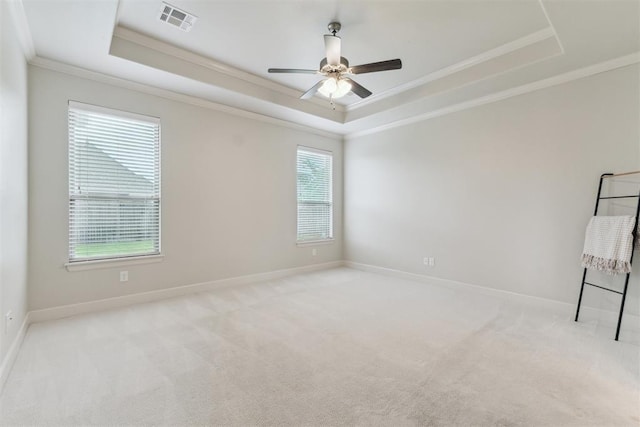 18813 Windy Way Rd, Edmond, OK 73012 - carpeted spare room featuring a raised ceiling, ornamental molding, baseboards, and a ceiling fan