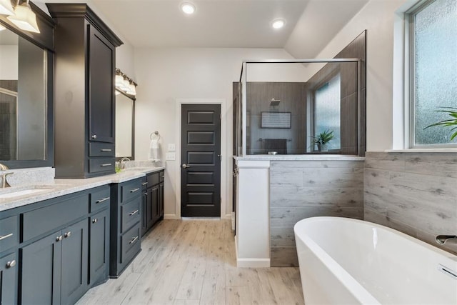 18813 Windy Way Rd, Edmond, OK 73012 - full bath with a shower stall, a freestanding bath, double vanity, wood finished floors, and recessed lighting