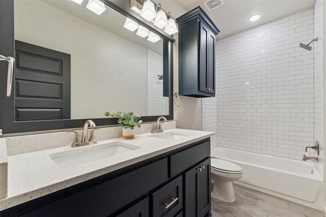 18813 Windy Way Rd, Edmond, OK 73012 - full bathroom with toilet, double vanity, bathtub / shower combination, and wood finished floors