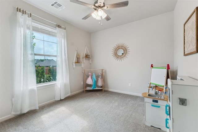 18813 Windy Way Rd, Edmond, OK 73012 - playroom featuring plenty of natural light, carpet floors, ceiling fan, and baseboards