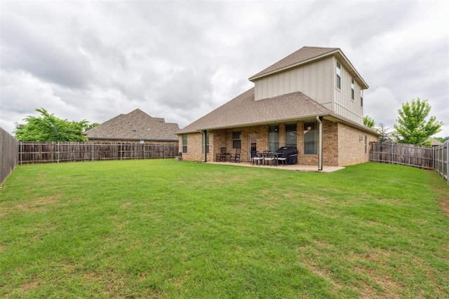 18813 Windy Way Rd, Edmond, OK 73012 - back of house with a patio area, brick siding, and roof with shingles