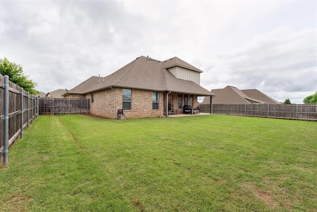 18813 Windy Way Rd, Edmond, OK 73012 - rear view of house with a patio area, brick siding, and a shingled roof