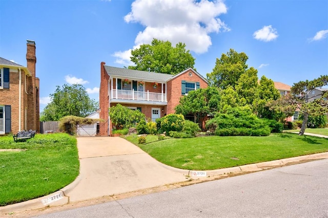 2721 NW 45th St, Oklahoma City, OK 73112 - view of front of home with a gate, brick siding, and a balcony