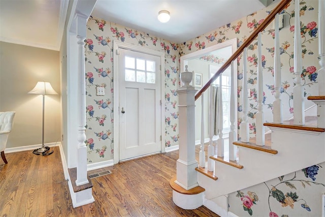 2721 NW 45th St, Oklahoma City, OK 73112 - foyer entrance featuring stairway, wood finished floors, wallpapered walls, and ornamental molding