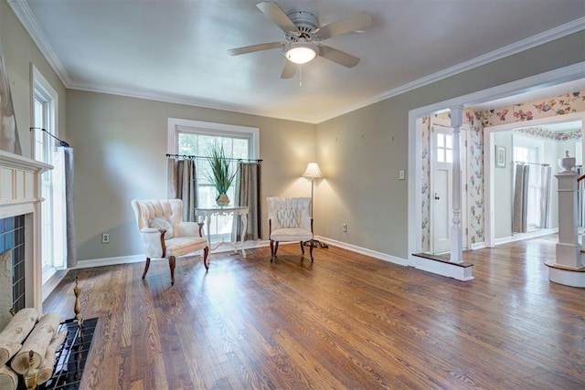 2721 NW 45th St, Oklahoma City, OK 73112 - living area featuring plenty of natural light, wood finished floors, a fireplace, a ceiling fan, and ornamental molding