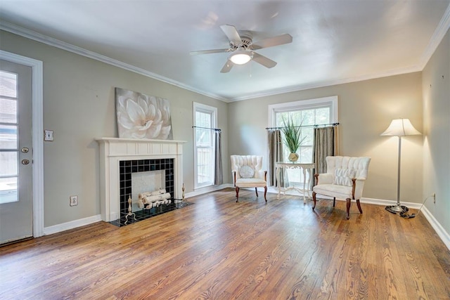 2721 NW 45th St, Oklahoma City, OK 73112 - living area with wood finished floors, a fireplace, a ceiling fan, and crown molding
