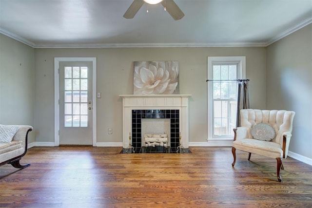 2721 NW 45th St, Oklahoma City, OK 73112 - sitting room with plenty of natural light, wood finished floors, a ceiling fan, crown molding, and a tile fireplace