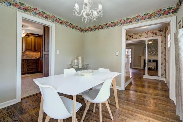 2721 NW 45th St, Oklahoma City, OK 73112 - dining room featuring a chandelier, wood finished floors, and a fireplace