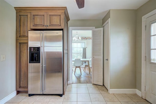2721 NW 45th St, Oklahoma City, OK 73112 - kitchen featuring stainless steel refrigerator with ice dispenser, a chandelier, light tile patterned floors, and brown cabinets