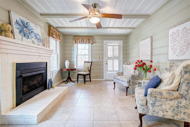 2721 NW 45th St, Oklahoma City, OK 73112 - living room featuring ceiling fan, light tile patterned flooring, and a brick fireplace
