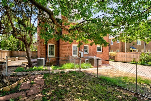 2721 NW 45th St, Oklahoma City, OK 73112 - rear view of property featuring brick siding and a chimney