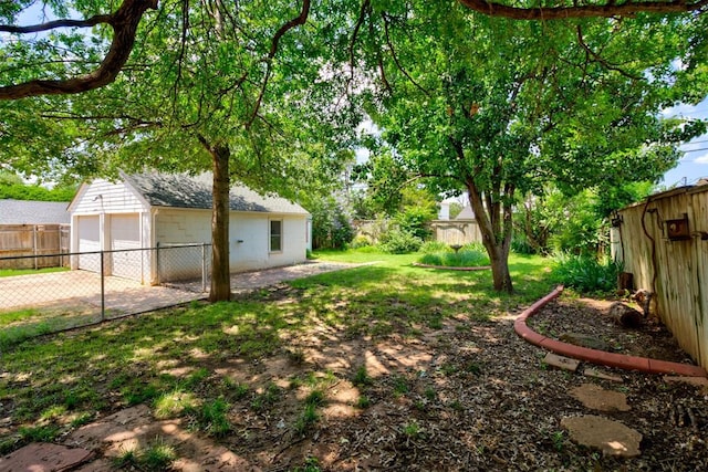2721 NW 45th St, Oklahoma City, OK 73112 - fenced backyard featuring an outbuilding and a garage
