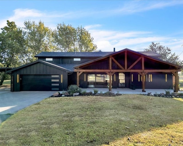 21700 N Rockwell Ave, Edmond, OK 73012 - view of front of home with an attached garage, a front yard, concrete driveway, and covered porch