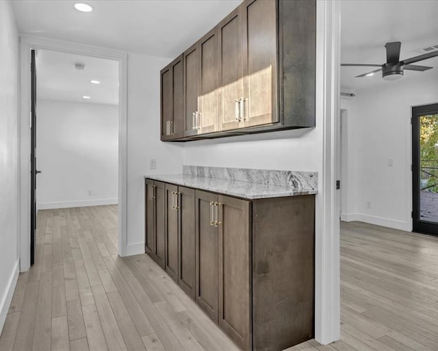 21700 N Rockwell Ave, Edmond, OK 73012 - kitchen with light wood finished floors, a ceiling fan, dark brown cabinetry, baseboards, and recessed lighting