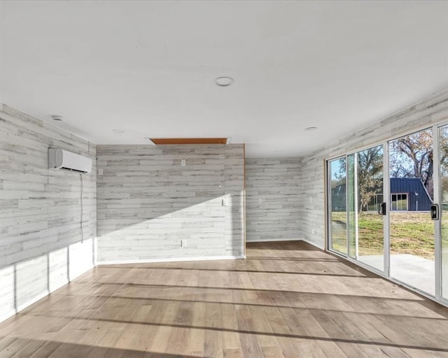 21700 N Rockwell Ave, Edmond, OK 73012 - unfurnished room featuring hardwood / wood-style floors and a wall mounted AC