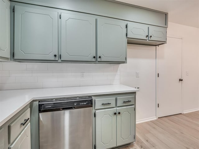 4709 Wilcox Ln, Yukon, OK 73099 - kitchen with dishwasher, light wood-type flooring, decorative backsplash, and light countertops