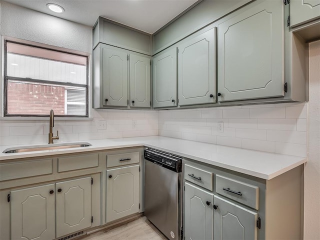 4709 Wilcox Ln, Yukon, OK 73099 - kitchen with stainless steel dishwasher, a sink, decorative backsplash, and light countertops