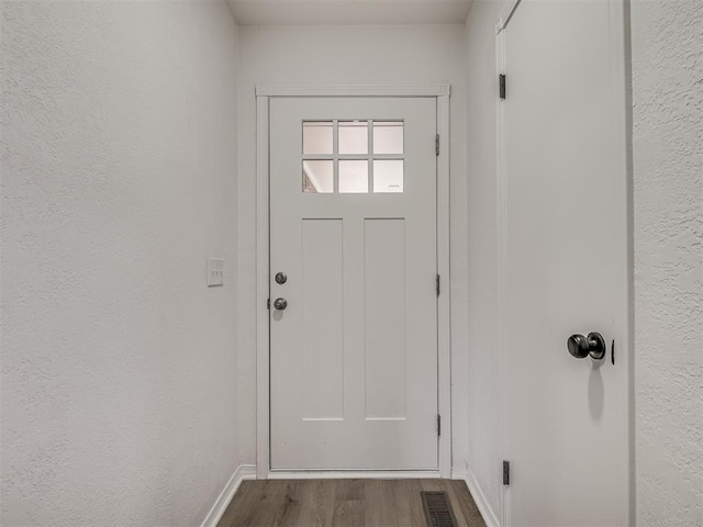 4709 Wilcox Ln, Yukon, OK 73099 - doorway to outside featuring dark wood-style flooring and baseboards