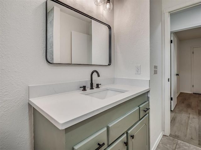 4709 Wilcox Ln, Yukon, OK 73099 - bathroom with vanity, a textured wall, and baseboards
