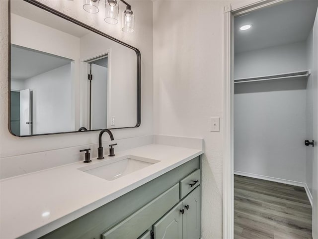 4709 Wilcox Ln, Yukon, OK 73099 - bathroom featuring vanity, wood finished floors, and baseboards