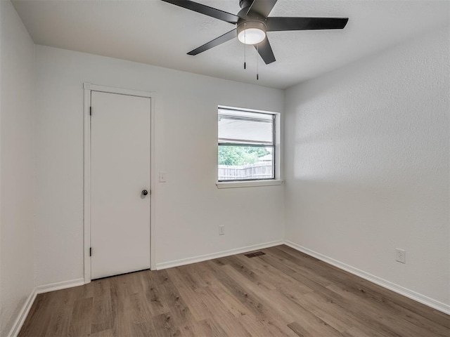 4709 Wilcox Ln, Yukon, OK 73099 - empty room featuring wood finished floors, a ceiling fan, and baseboards