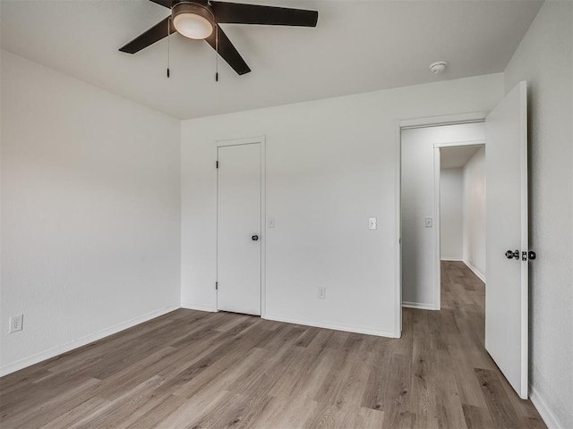 4709 Wilcox Ln, Yukon, OK 73099 - unfurnished bedroom featuring wood finished floors, baseboards, and ceiling fan