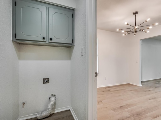 4709 Wilcox Ln, Yukon, OK 73099 - washroom with hookup for an electric dryer, light wood finished floors, cabinet space, a chandelier, and baseboards