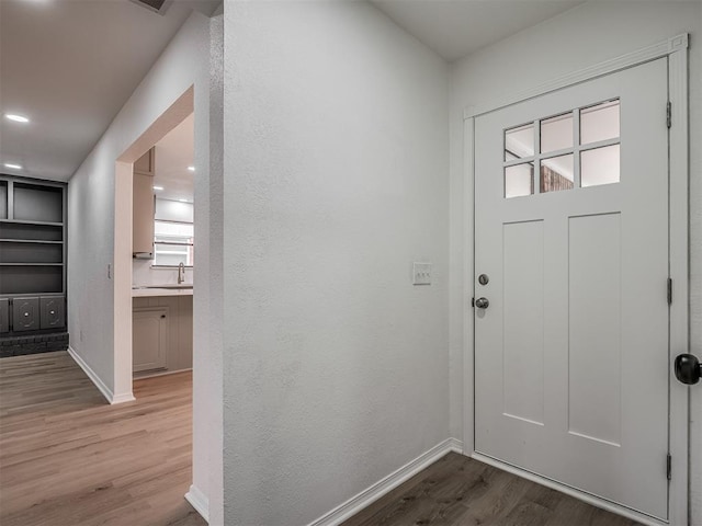 4709 Wilcox Ln, Yukon, OK 73099 - foyer featuring wood finished floors, baseboards, and a textured wall