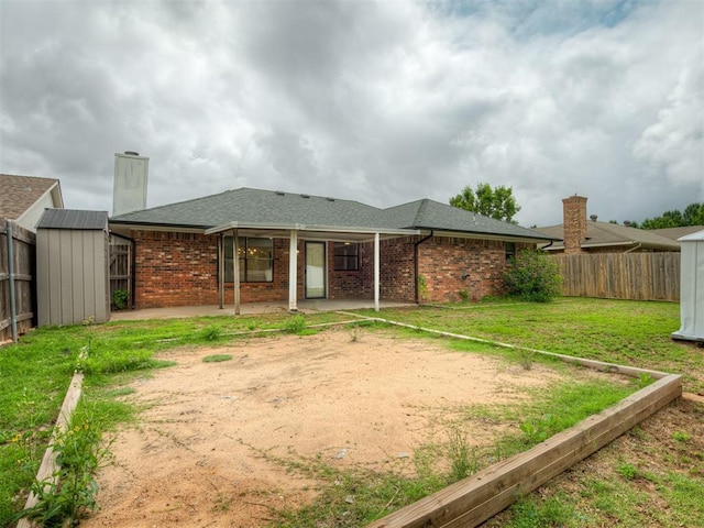 4709 Wilcox Ln, Yukon, OK 73099 - rear view of property with a patio, brick siding, a chimney, and a shingled roof