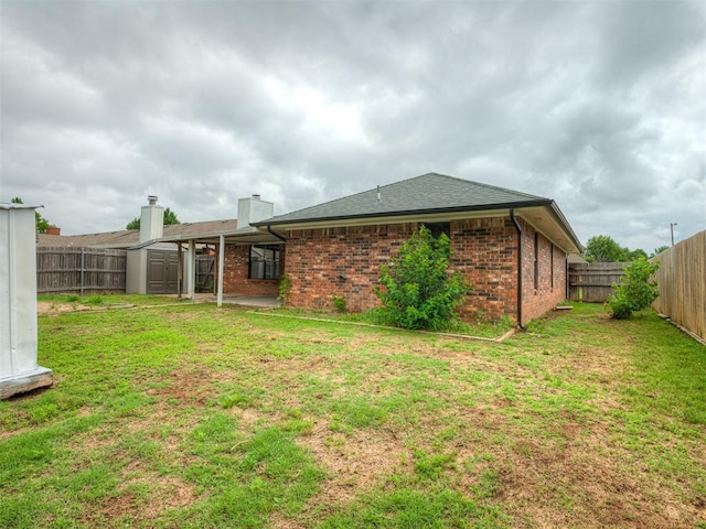 4709 Wilcox Ln, Yukon, OK 73099 - back of property with brick siding, a chimney, and a shingled roof