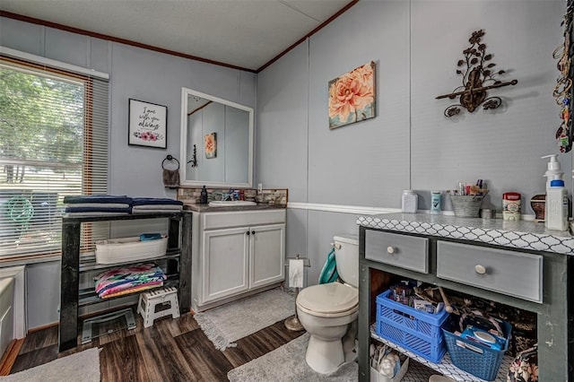 13903 Pleasant Ridge Rd, Jones, OK 73049 - bathroom featuring ornamental molding, wood finished floors, healthy amount of natural light, vanity, and toilet
