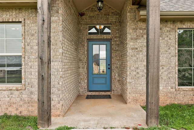 7720 Hawk Ln, Guthrie, OK 73044 - doorway to property with brick siding and a shingled roof