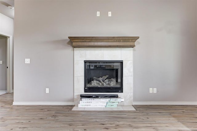 7720 Hawk Ln, Guthrie, OK 73044 - detailed view of wood finished floors, baseboards, and a tile fireplace
