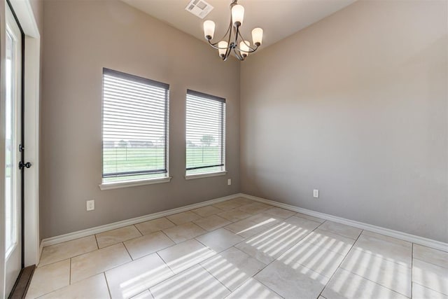 7720 Hawk Ln, Guthrie, OK 73044 - empty room with a chandelier, light tile patterned floors, and baseboards