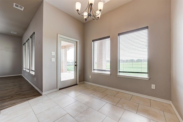 7720 Hawk Ln, Guthrie, OK 73044 - foyer featuring plenty of natural light, a chandelier, baseboards, and light tile patterned floors