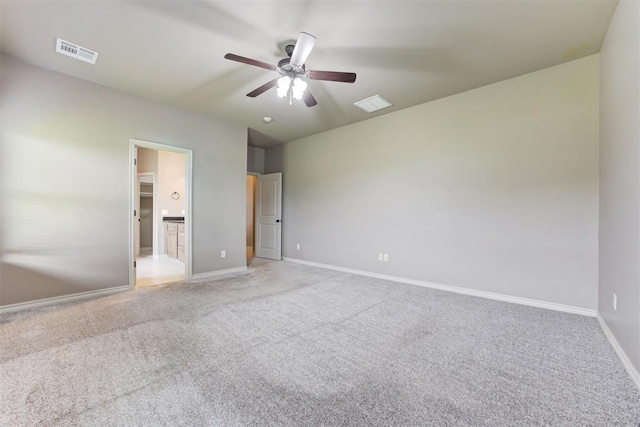 7720 Hawk Ln, Guthrie, OK 73044 - unfurnished bedroom featuring light colored carpet, baseboards, connected bathroom, and ceiling fan
