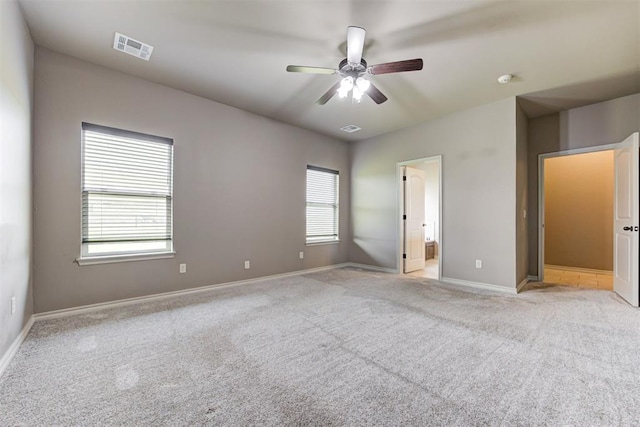 7720 Hawk Ln, Guthrie, OK 73044 - unfurnished bedroom featuring light colored carpet, baseboards, ensuite bath, and ceiling fan