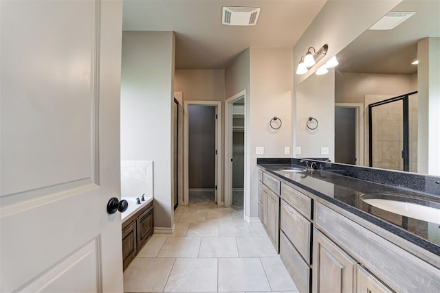 7720 Hawk Ln, Guthrie, OK 73044 - bathroom with a stall shower, double vanity, tile patterned floors, baseboards, and a bathtub