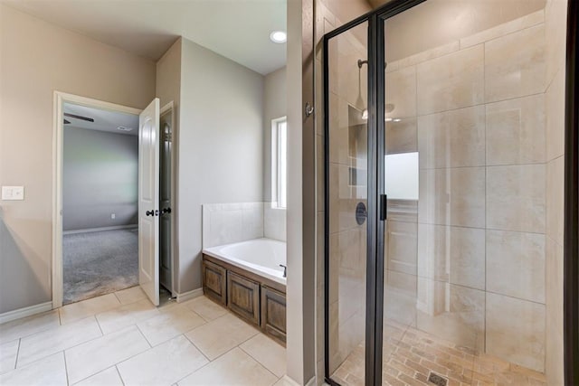7720 Hawk Ln, Guthrie, OK 73044 - bathroom with a garden tub, a shower stall, tile patterned floors, and baseboards
