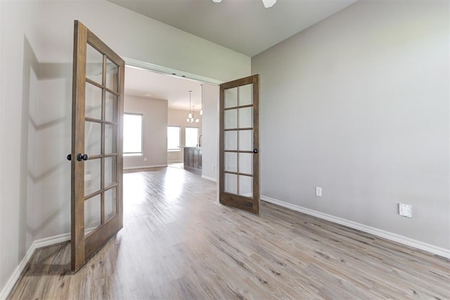 7720 Hawk Ln, Guthrie, OK 73044 - empty room with french doors, wood finished floors, and baseboards