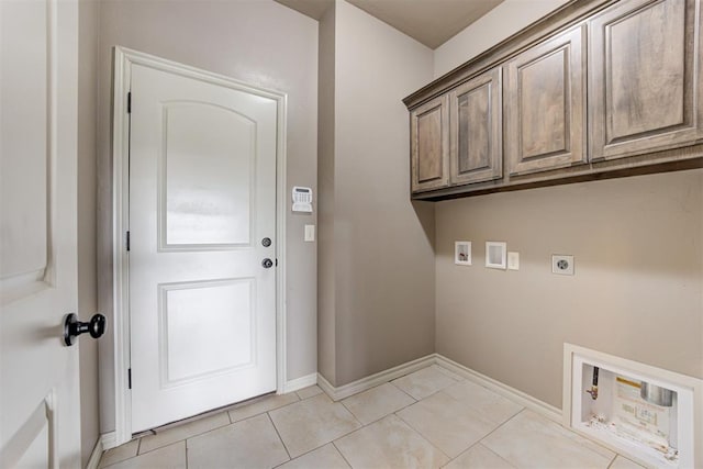 7720 Hawk Ln, Guthrie, OK 73044 - washroom featuring hookup for an electric dryer, hookup for a washing machine, cabinet space, baseboards, and light tile patterned floors