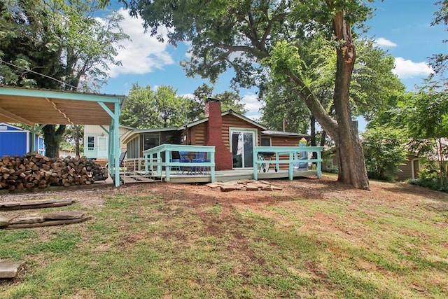 21306 E 10th St, Hinton, OK 73047 - back of property featuring a wooden deck, a lawn, and a chimney